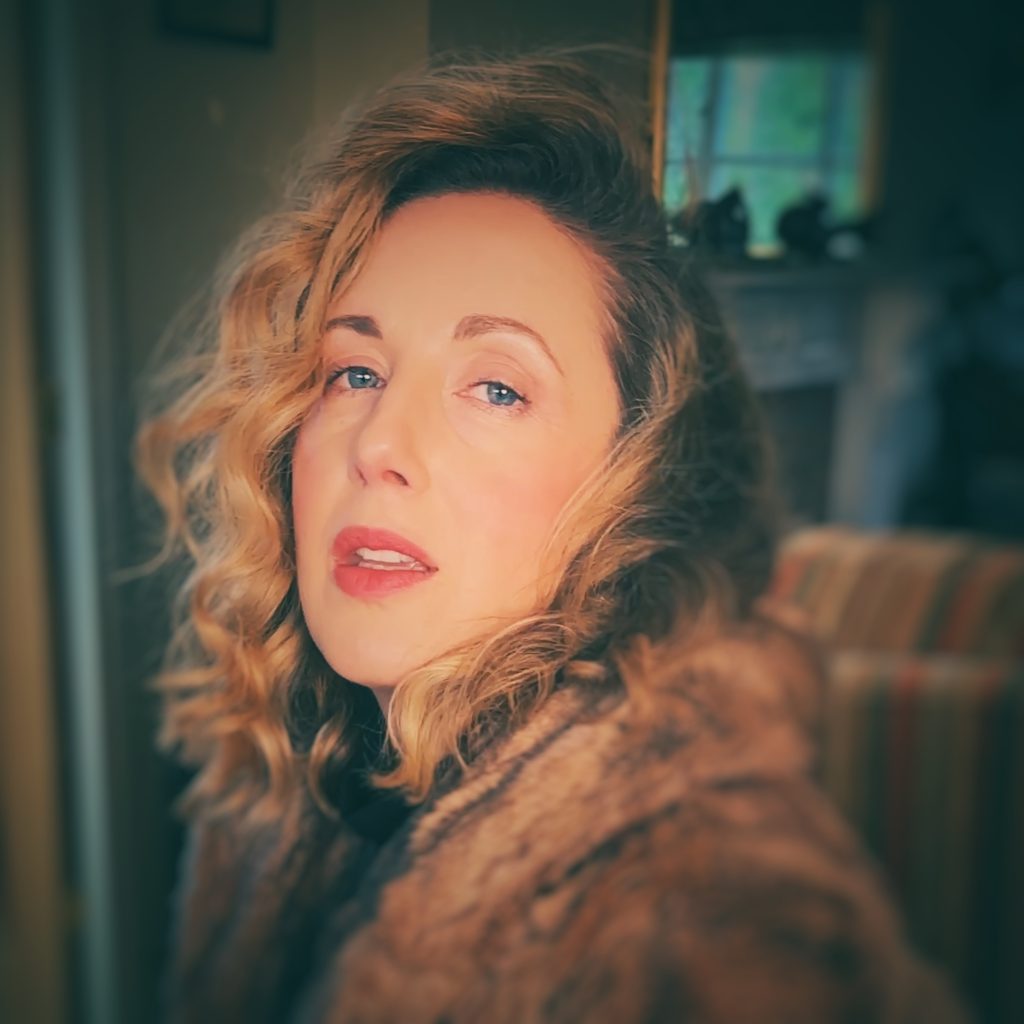 Becki Biggins, a female singer and saxophonist, looking towards the camera